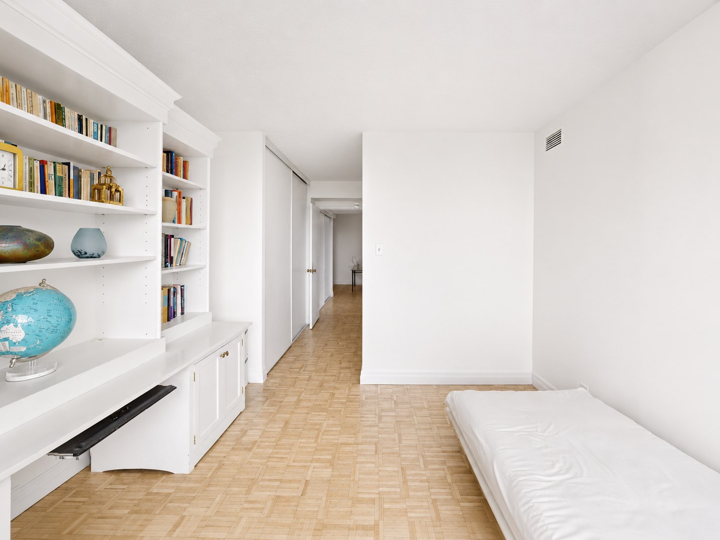 Bedroom with built-in bookshelf